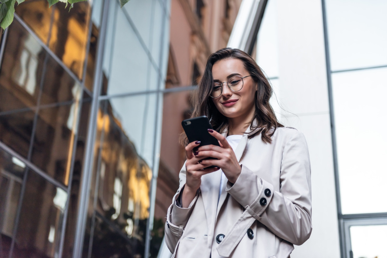 Woman paying rent on mobile device