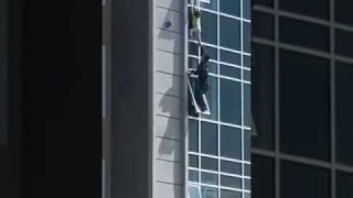 The man climbed out of his eighth floor apartment window to catch the helpless three-year-old girl.